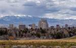 landscape view of the Reno central business district with snowcapped mountains in the distance beyond