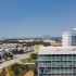 panoramic view of Plano office space buildings in the foreground and nearby residential villas in the background