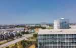 panoramic view of Plano office space buildings in the foreground and nearby residential villas in the background