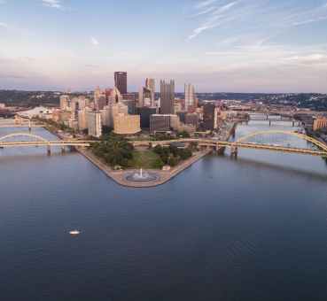 aerial apnoramic view of pittsburgh central business district buildings on island connected by bridges across the river